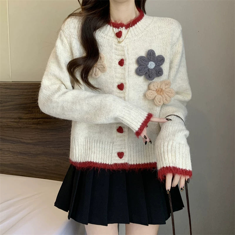 Ladies playful pullover with heart-shaped button closure and floral appliqués Chic and Style
