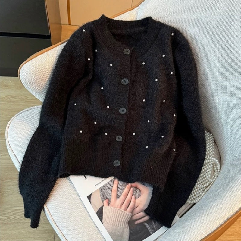 Elegant ladies' knit cardigan with trendy pearl accents. Chic and stylish.