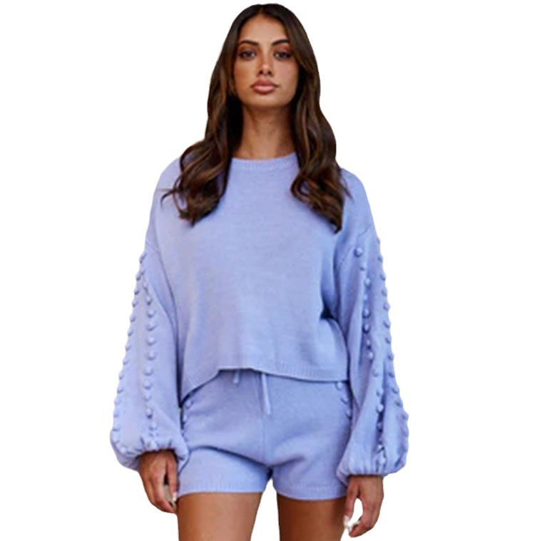 Trendy women's outfit consisting of an asymmetric sweater and shorts with decorative details Chic and Style