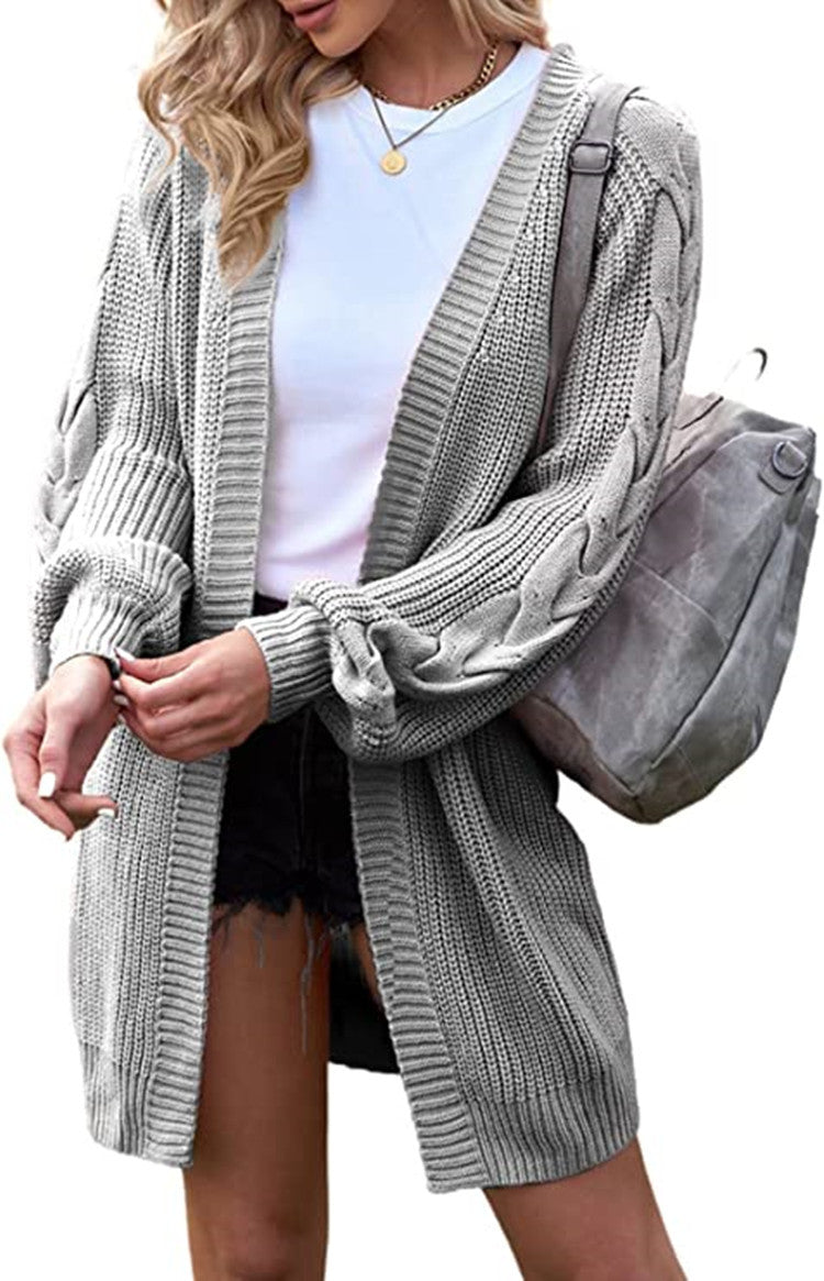 Cardigan knitted for women with voluminous sleeves and cable knit details Chic und Stil