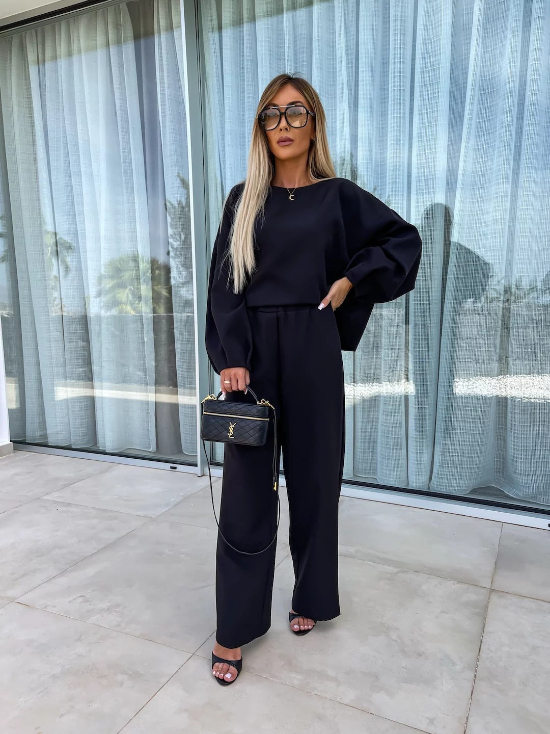 Elegant and modern women's two-piece set with a loose top and chic palazzo pants.