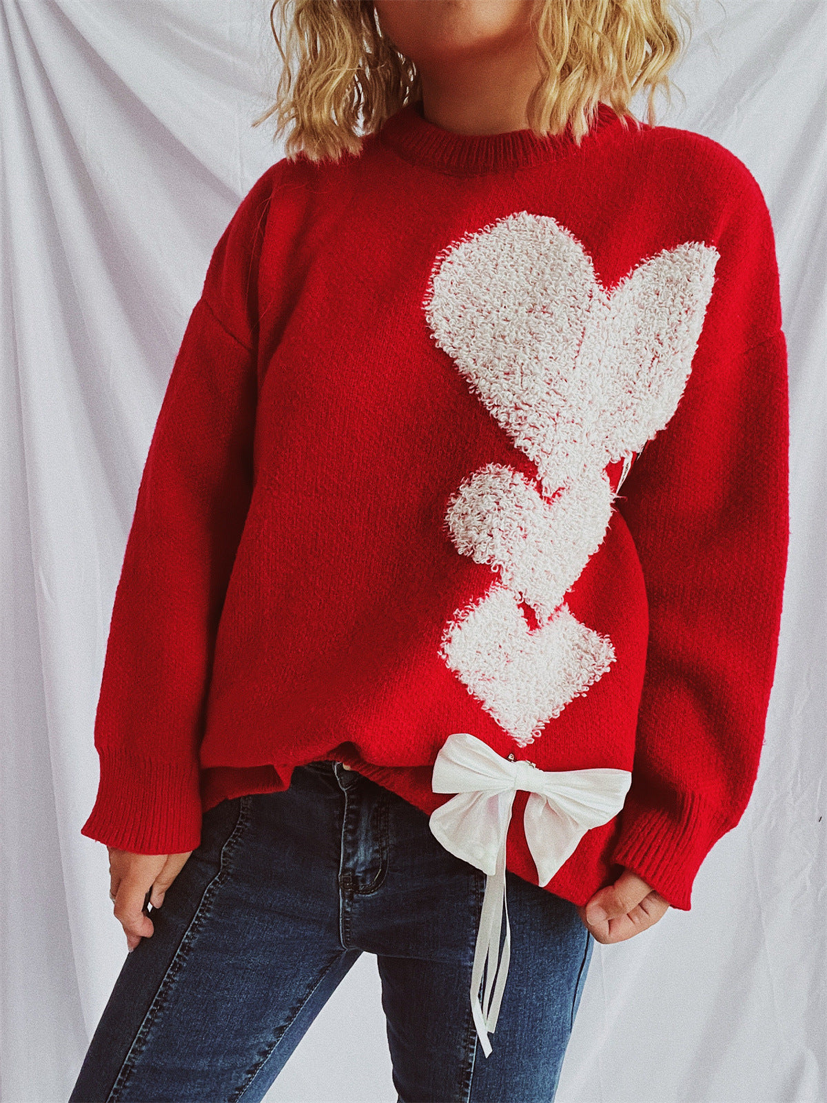 Pull femme avec design en forme de cœur et nœud décoratif Chic und Stil