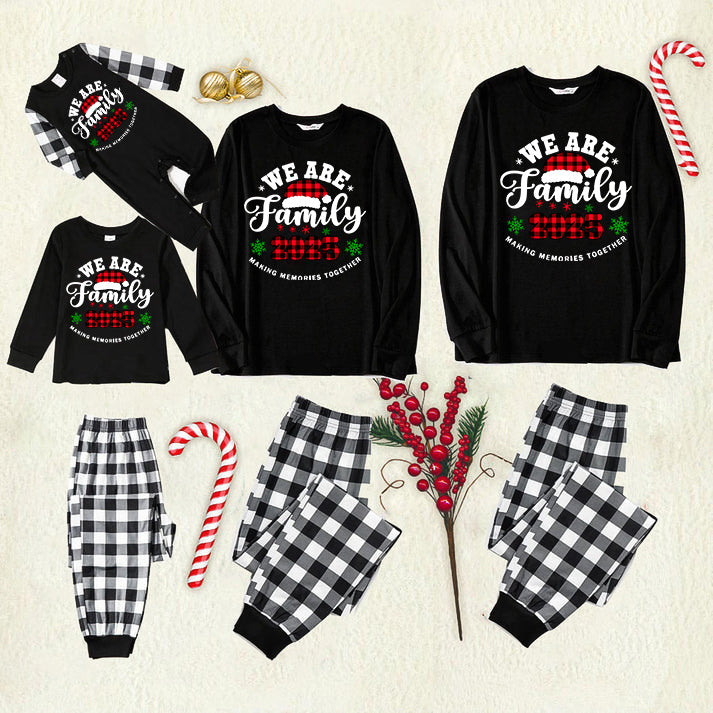 Chic und Stil | "We are Family2025" Santa Hat Monogram Print Black Long Sleeve Shirt with Black and White Checkered Pants Family Matching Pajamas