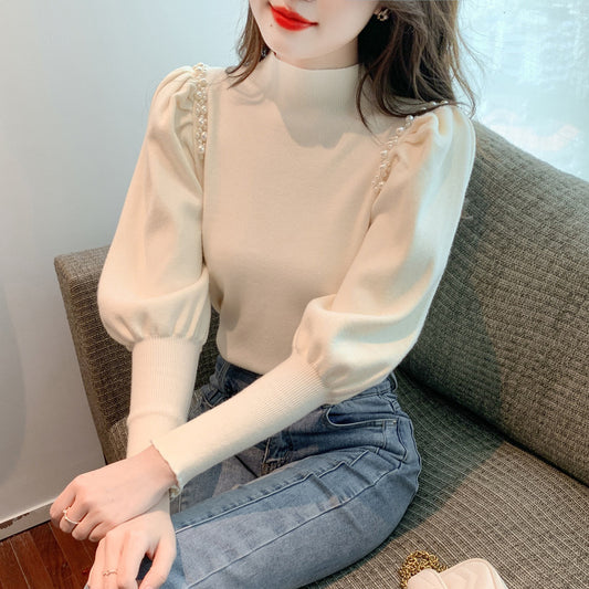 Pull élégant pour femmes avec des manches bouffantes et des détails en perles Chic und Stil
