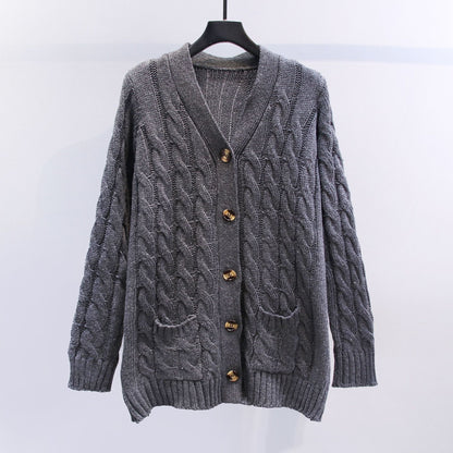 Knitted women's pullover with a structured cable pattern and practical pockets Chic and Style