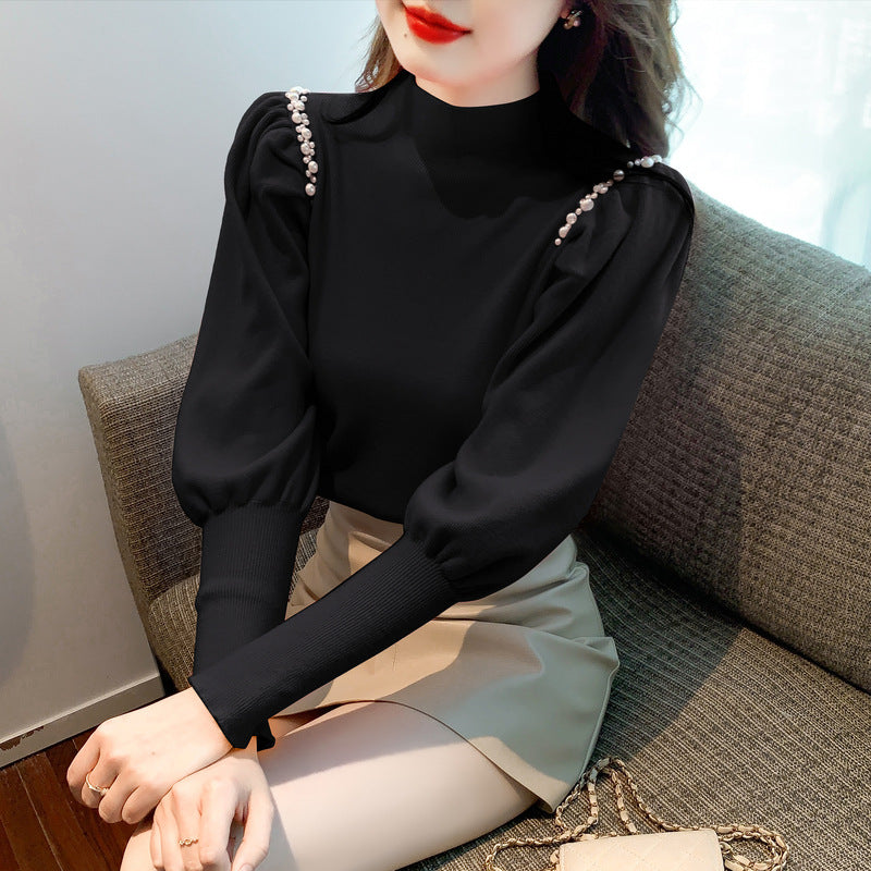 Pull élégant pour femmes avec des manches bouffantes et des détails en perles Chic und Stil