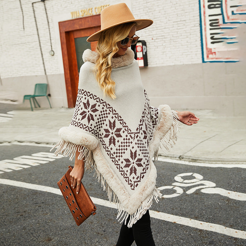 Elegant women's poncho with decorative fringe design and faux fur trim Chic and Style