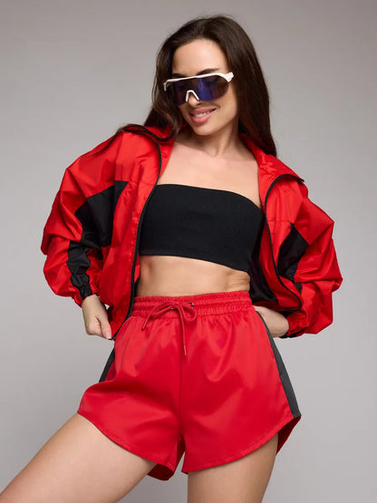 Women's athletic workout clothing with a highly functional jacket and chic stylish shorts