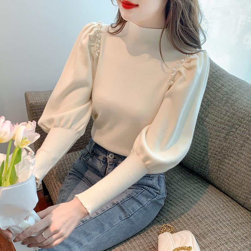 Pull élégant pour femmes avec des manches bouffantes et des détails en perles Chic und Stil