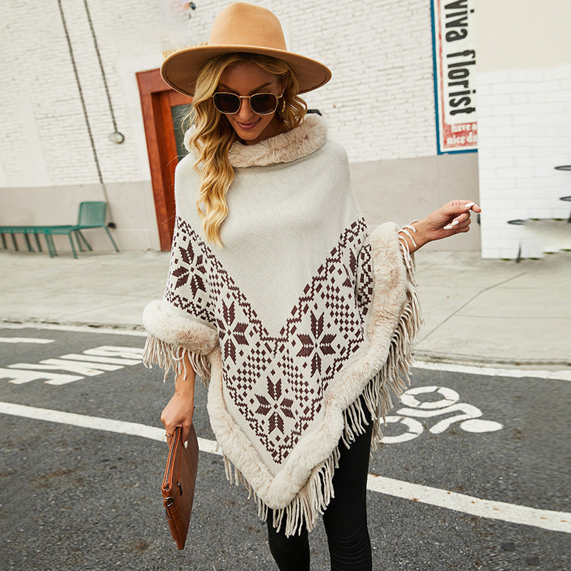 Elegant women's poncho with decorative fringe design and faux fur trim Chic and Style