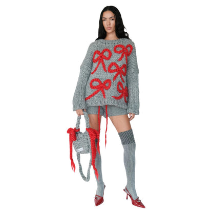 Pull en gros tricot pour femmes avec un design de nœud ludique Chic und Stil
