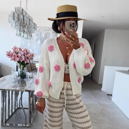 Women's comfortable knit cardigan with playful floral appliqués. Chic and stylish.