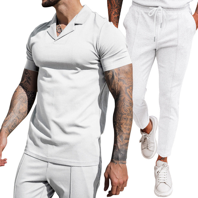 Elegant men's short sleeve polo with textured design and matching slim-fit trousers Chic and Style