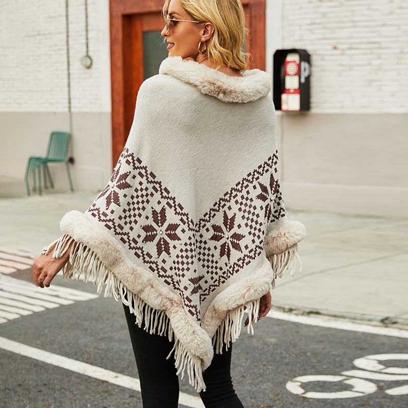Elegant women's poncho with decorative fringe design and faux fur trim Chic and Style