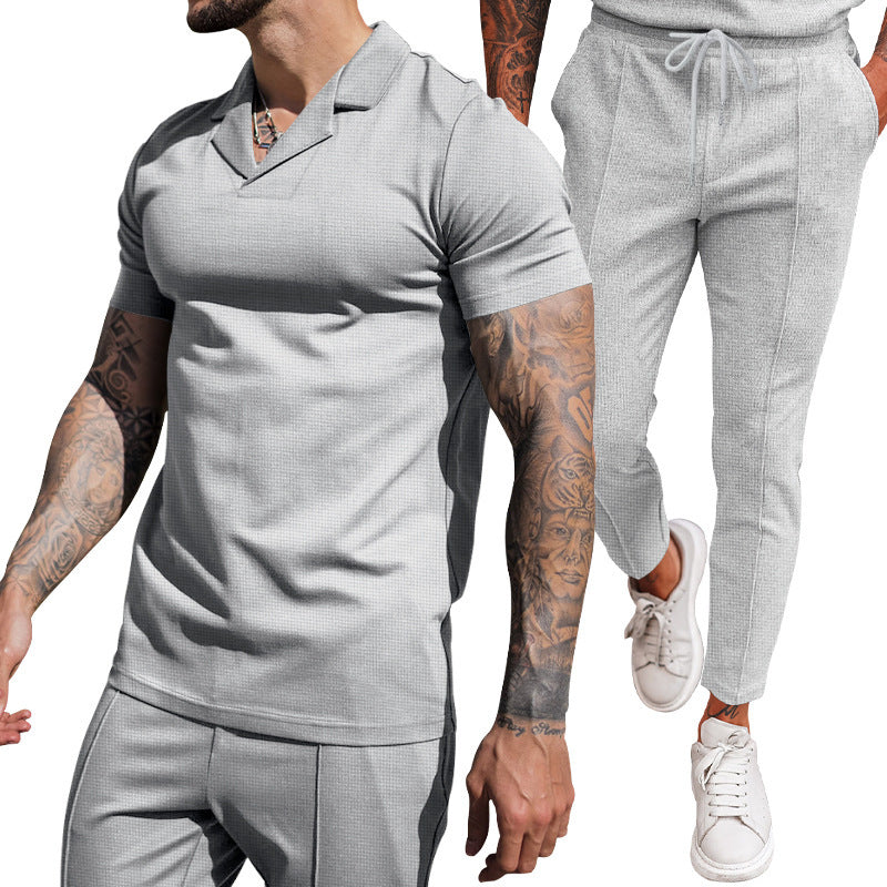 Elegant men's short sleeve polo with textured design and matching slim-fit trousers Chic and Style