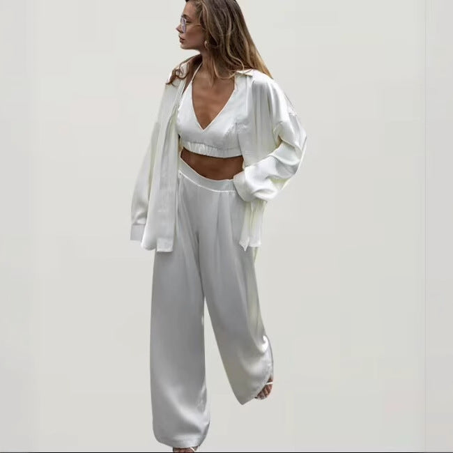 Women's set consisting of an elegant blouse, comfortable palazzo pants, and a trendy bralette Chic und Stil
