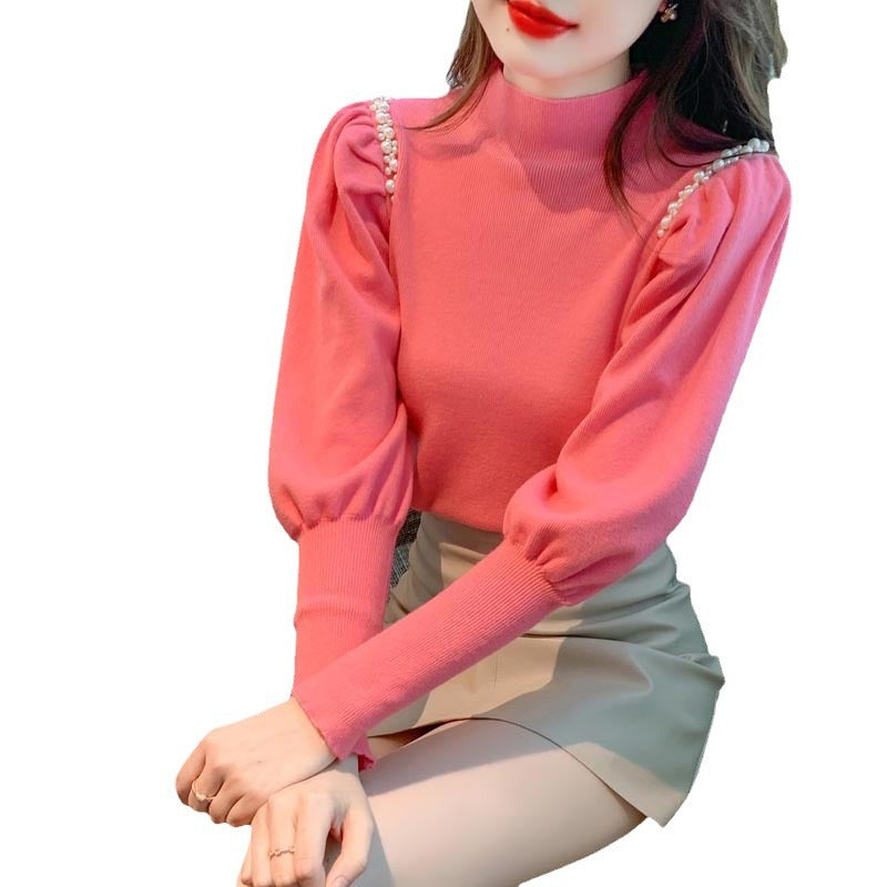 Pull élégant pour femmes avec des manches bouffantes et des détails en perles Chic und Stil