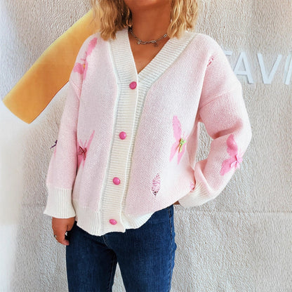 Dame cardigan avec un design de papillon ludique et fermeture à bouton Chic und Stil