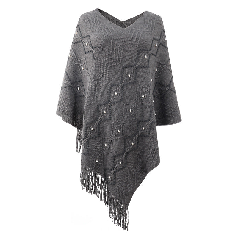 Chic and Style Elegant poncho for women with a striking textured pattern and decorative fringes