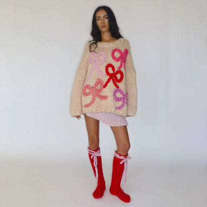 Pull en gros tricot pour femmes avec un design de nœud ludique Chic und Stil